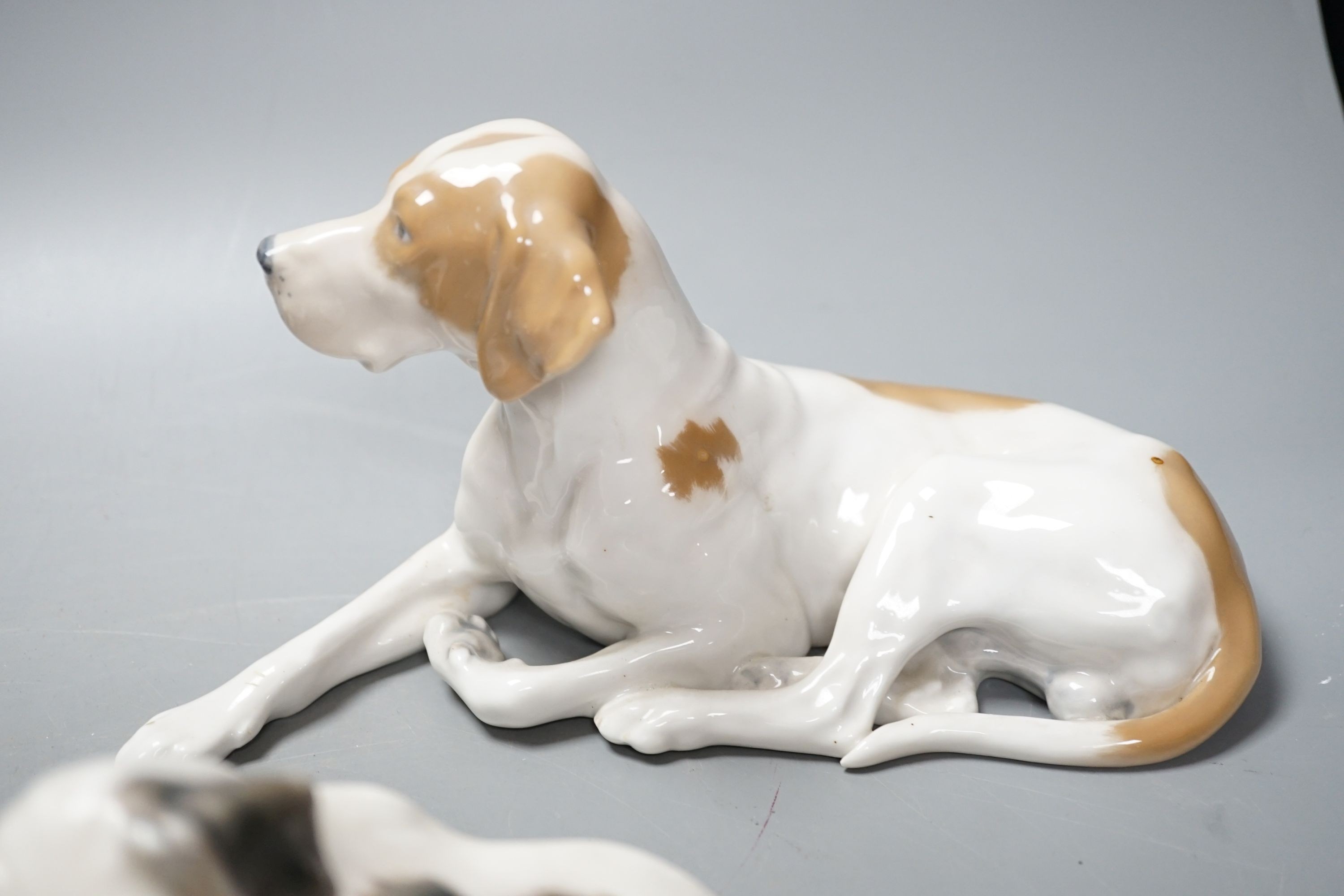 Two Royal Copenhagen figures of dogs and two Bing and Grondahl figures of dogs, largest 23 cms wide
